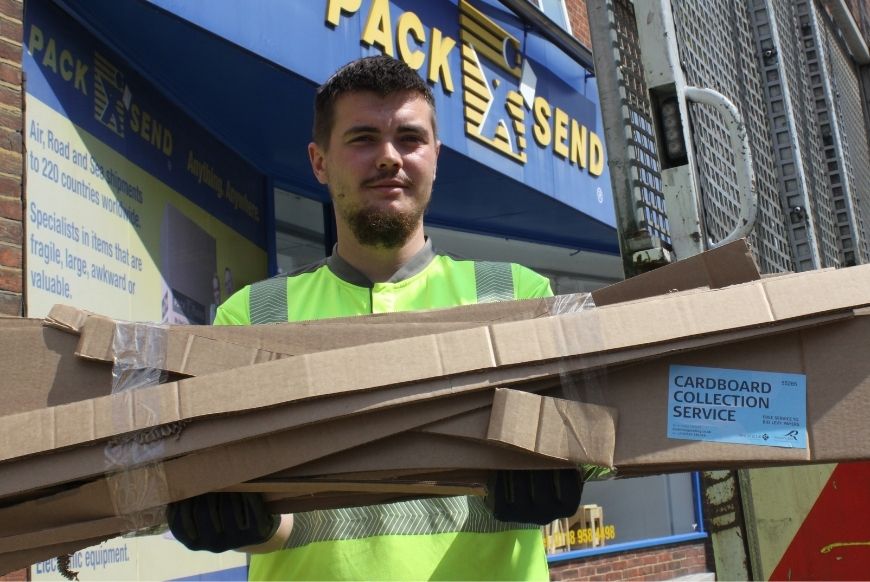 Man holding cardboard recycling outside Pack and Send store